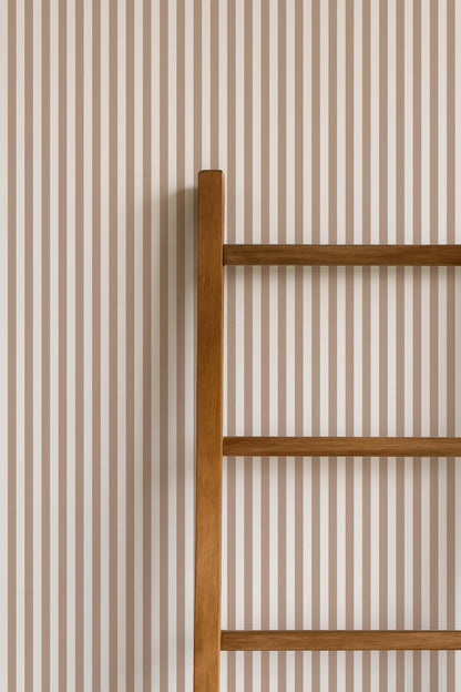 a wooden ladder leaning against a wall with horizontal stripes.