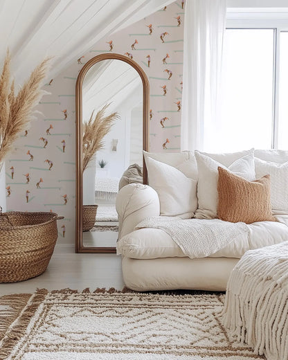 a cozy living room with a large mirror, a white sofa, and a woven basket. The room has a bohemian and eclectic style, with a mix of natural and textured elements.