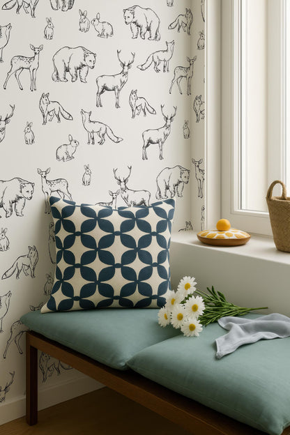 a wallpapered wall with a pattern of various animals, including deer, bears, and rabbits, as well as a window sill with a basket and a bouquet of white flowers.