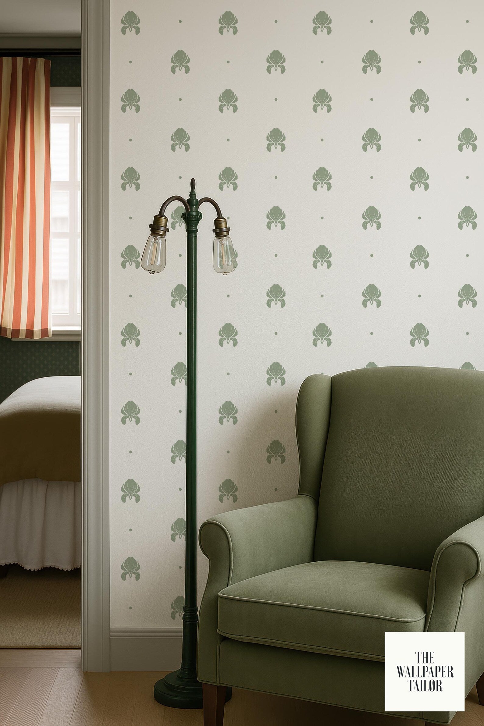 a green armchair and a lamp in a room with a striped curtain and a patterned wall.