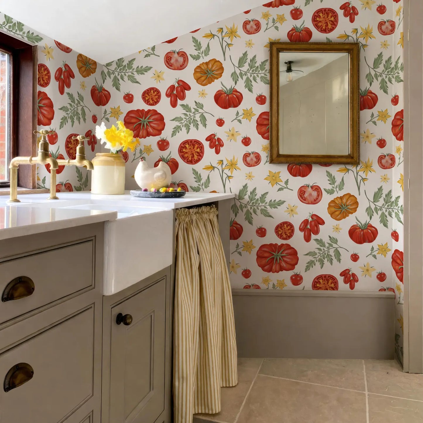a bathroom with a white sink, a mirror, and a wall covered in a vibrant tomato wallpaper. The bathroom also includes a cabinet and a window.