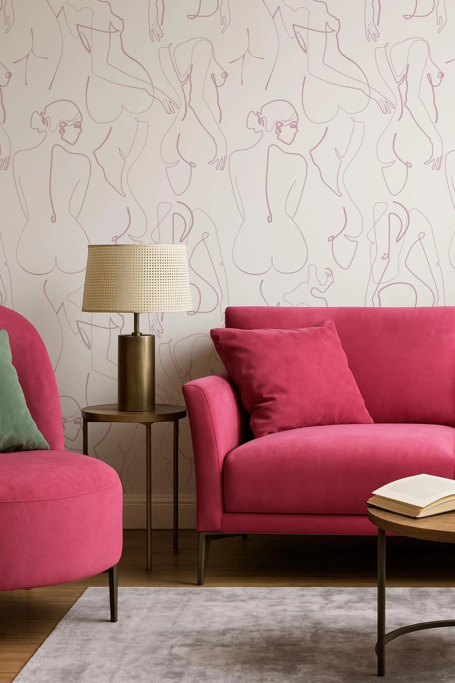 a modern living room with a pink sofa, a round wooden coffee table, and a lamp on a side table. The walls are decorated with a repeating pattern of abstract human figures in pink and white.
