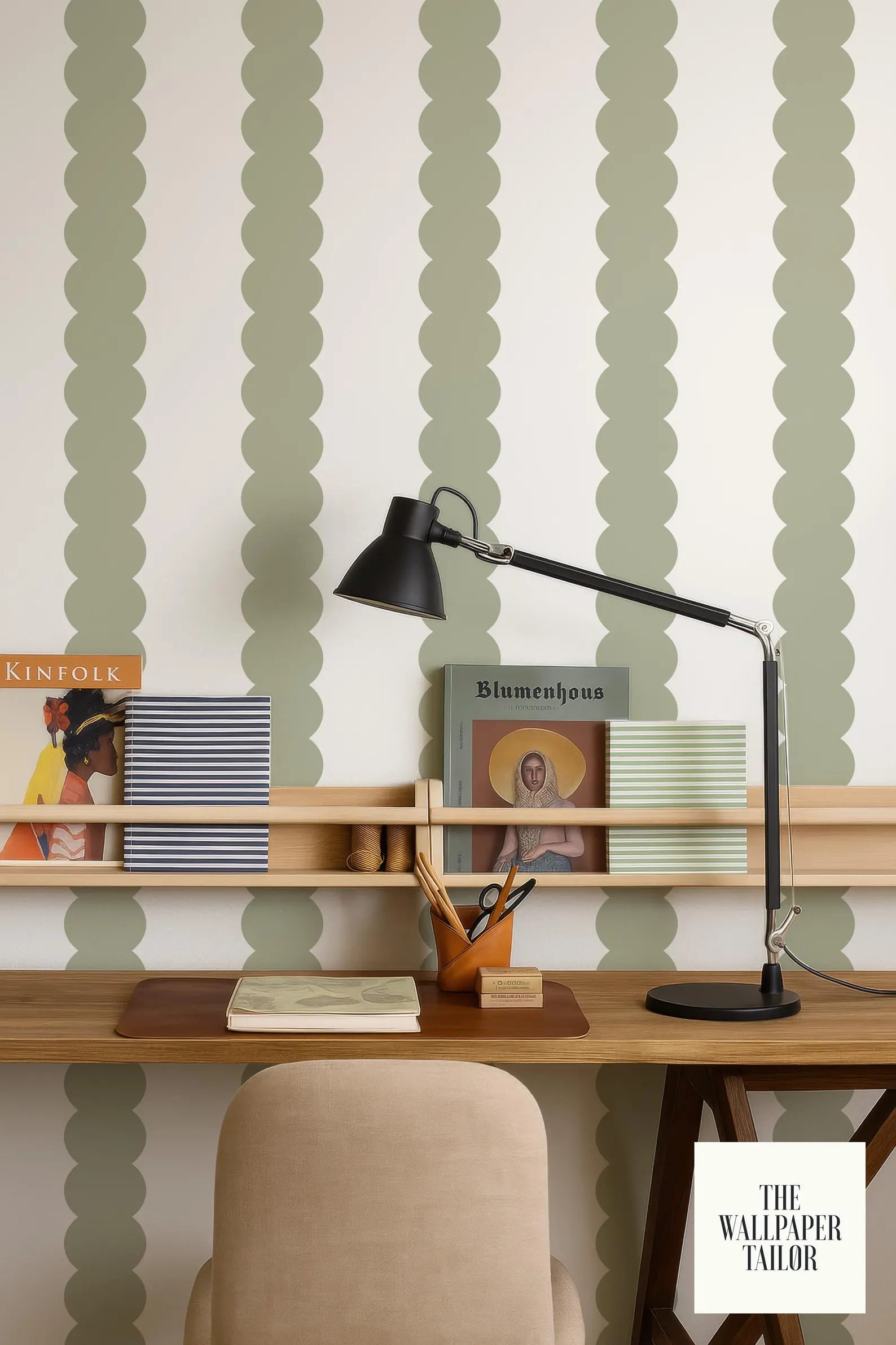 a wooden desk with a lamp, books, and a magazine rack, set against a wall with a repeating green and white pattern.