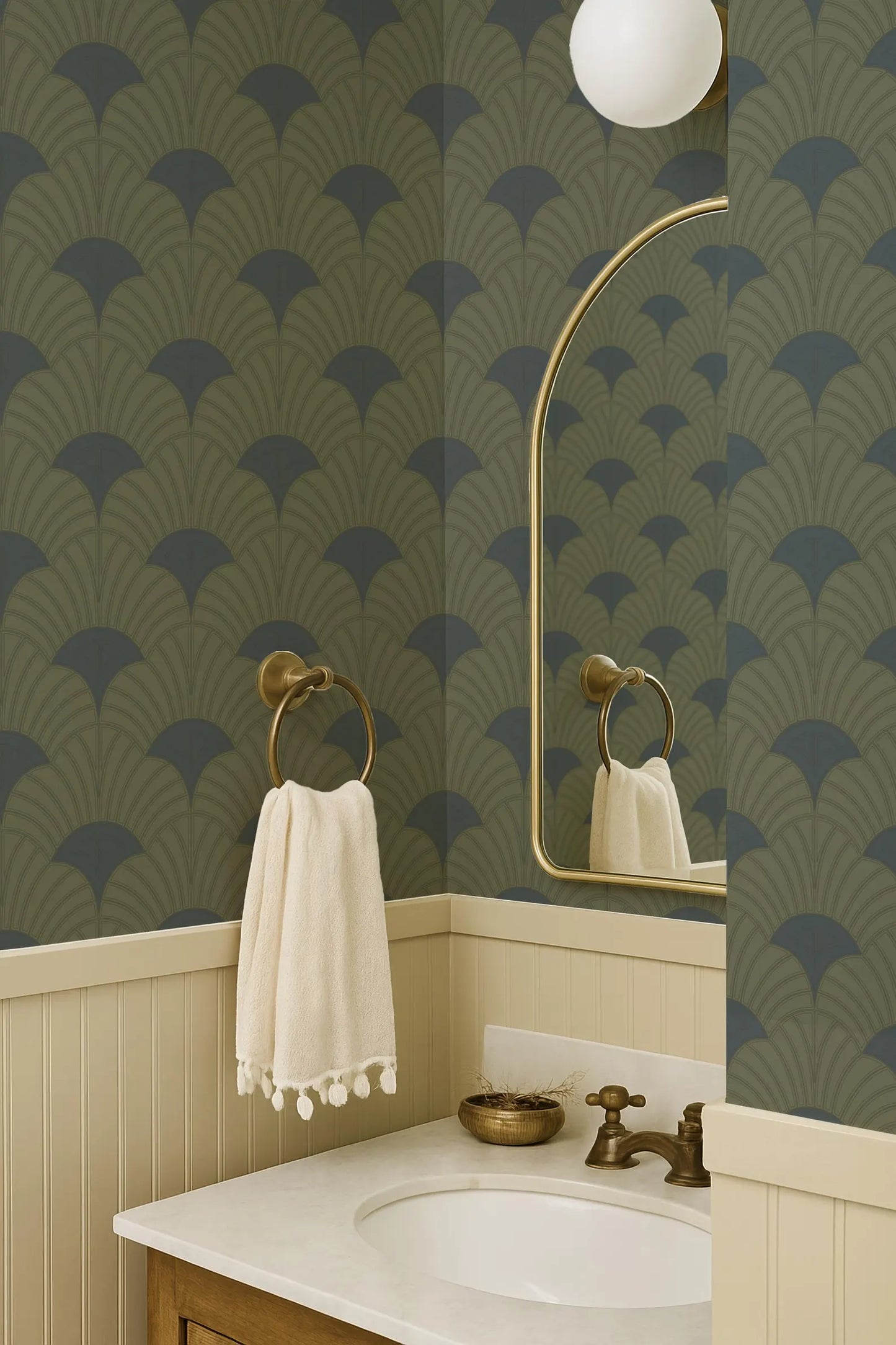 a bathroom with a white sink, a towel rack, and a mirror above it. The walls are covered in a patterned wallpaper, and the overall color scheme is a combination of green and blue.