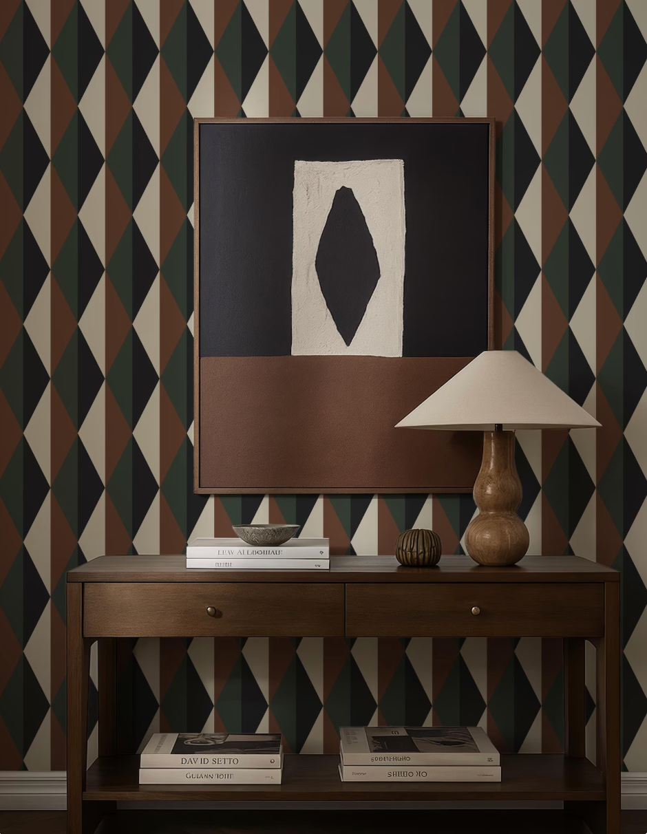 a wooden console table with a lamp, books, and a framed abstract artwork on the wall above it.