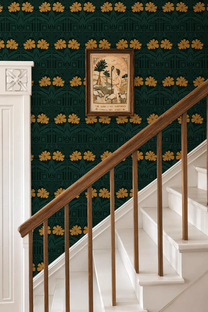 a staircase with a wooden railing and a framed artwork hanging on the wall above it. The artwork depicts a woman with a sheep, and the wall has a green and gold pattern. The staircase is white and has a white railing.