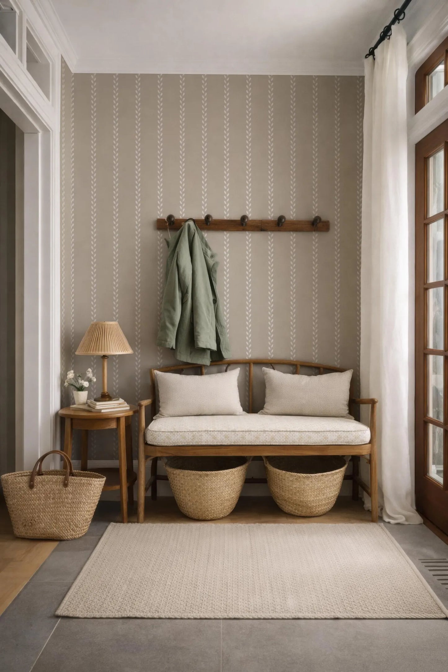 a cozy and inviting entryway with a wooden bench, a woven basket, and a wooden coat rack. The walls are adorned with a striped wallpaper, and a large window with white curtains allows natural light to enter the space.