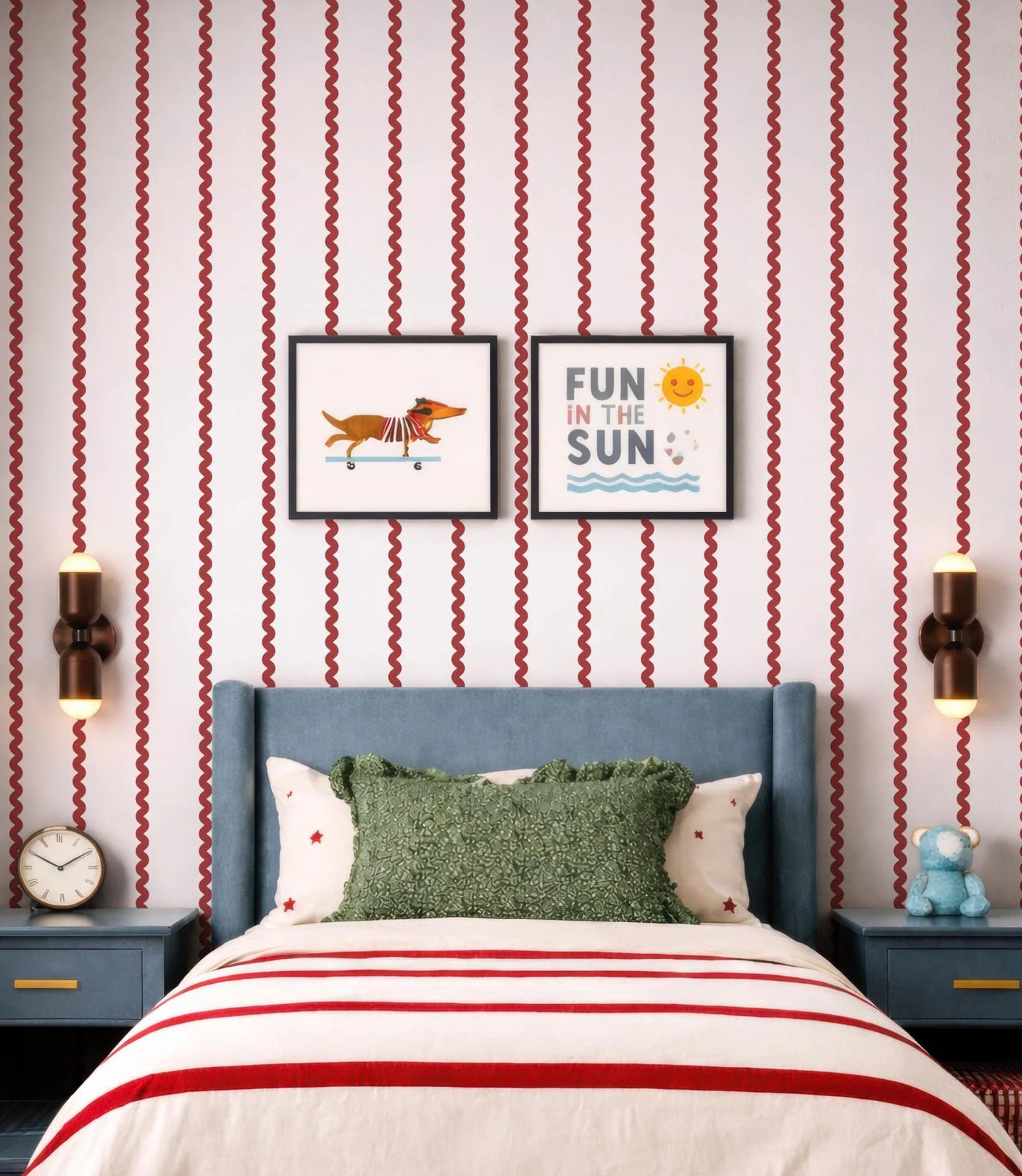 a bedroom with a blue headboard and a green throw pillow. Above the bed, there are two framed pictures on the wall, one depicting a dog and the other with the text "Fun in the Sun". The room also has a clock on the wall and a stuffed animal on a nightstand.