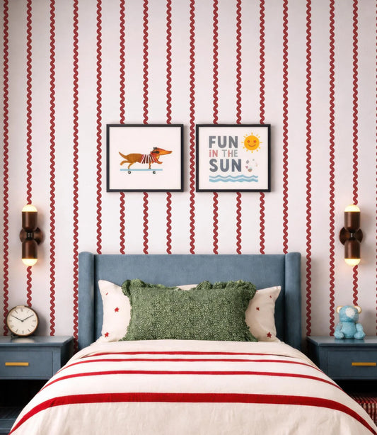 a bedroom with a blue headboard and a green throw pillow. Above the bed, there are two framed pictures on the wall, one depicting a dog and the other with the text "Fun in the Sun". The room also has a clock on the wall and a stuffed animal on a nightstand.