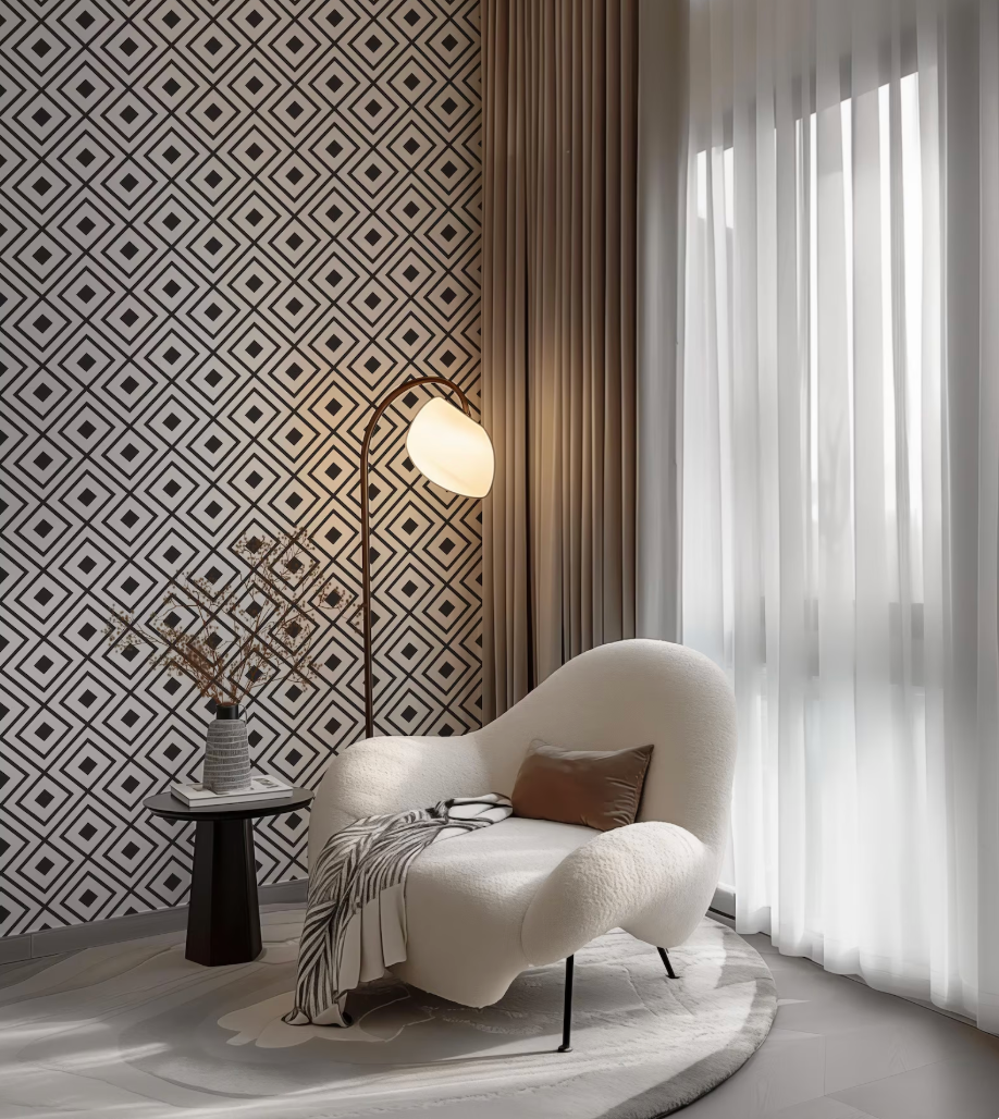 a modern living room with a white armchair, a floor lamp, and a patterned wallpaper.