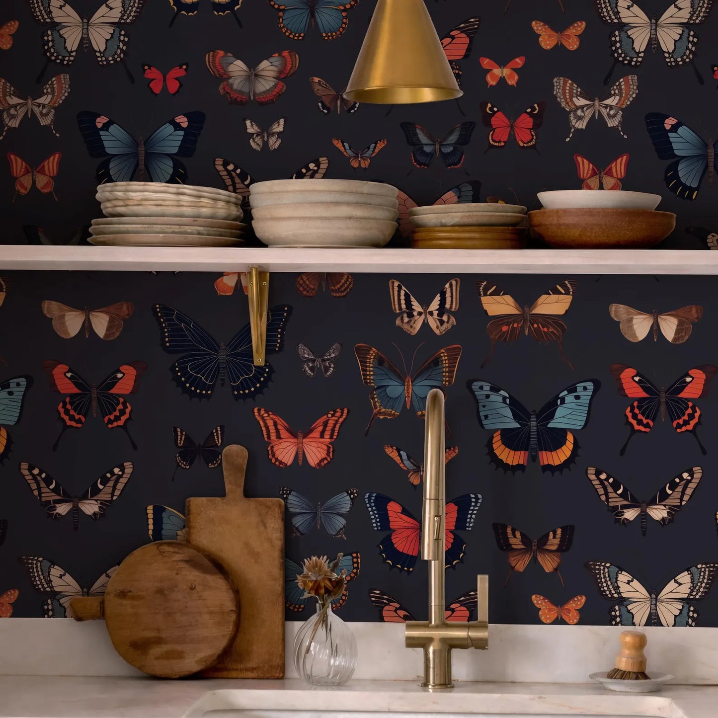 a kitchen counter with a variety of colorful butterflies and plates displayed on it. The butterflies are arranged in a visually appealing manner, creating a lively and vibrant atmosphere. The plates and bowls are neatly arranged on the counter, showcasing the kitchen's well-organized and stylish design.