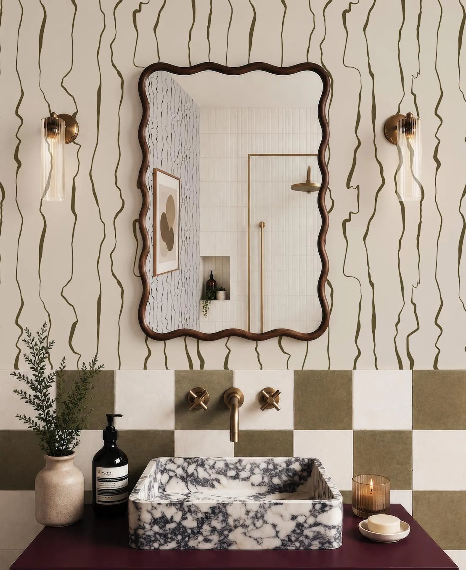 a bathroom with a marble-patterned sink, a large mirror, and a checkered tile backsplash. The bathroom also includes a potted plant, a soap dispenser, and a candle on the counter.