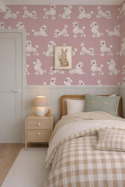 a cozy bedroom with a pink and white checkered bedspread, a wooden nightstand with a lamp, and a framed picture of a rabbit on the wall.