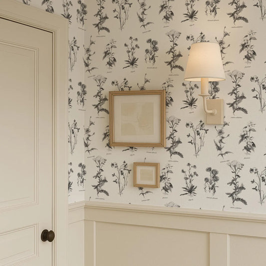 a wallpapered wall with a framed picture and a wall sconce, creating a cozy and inviting atmosphere.