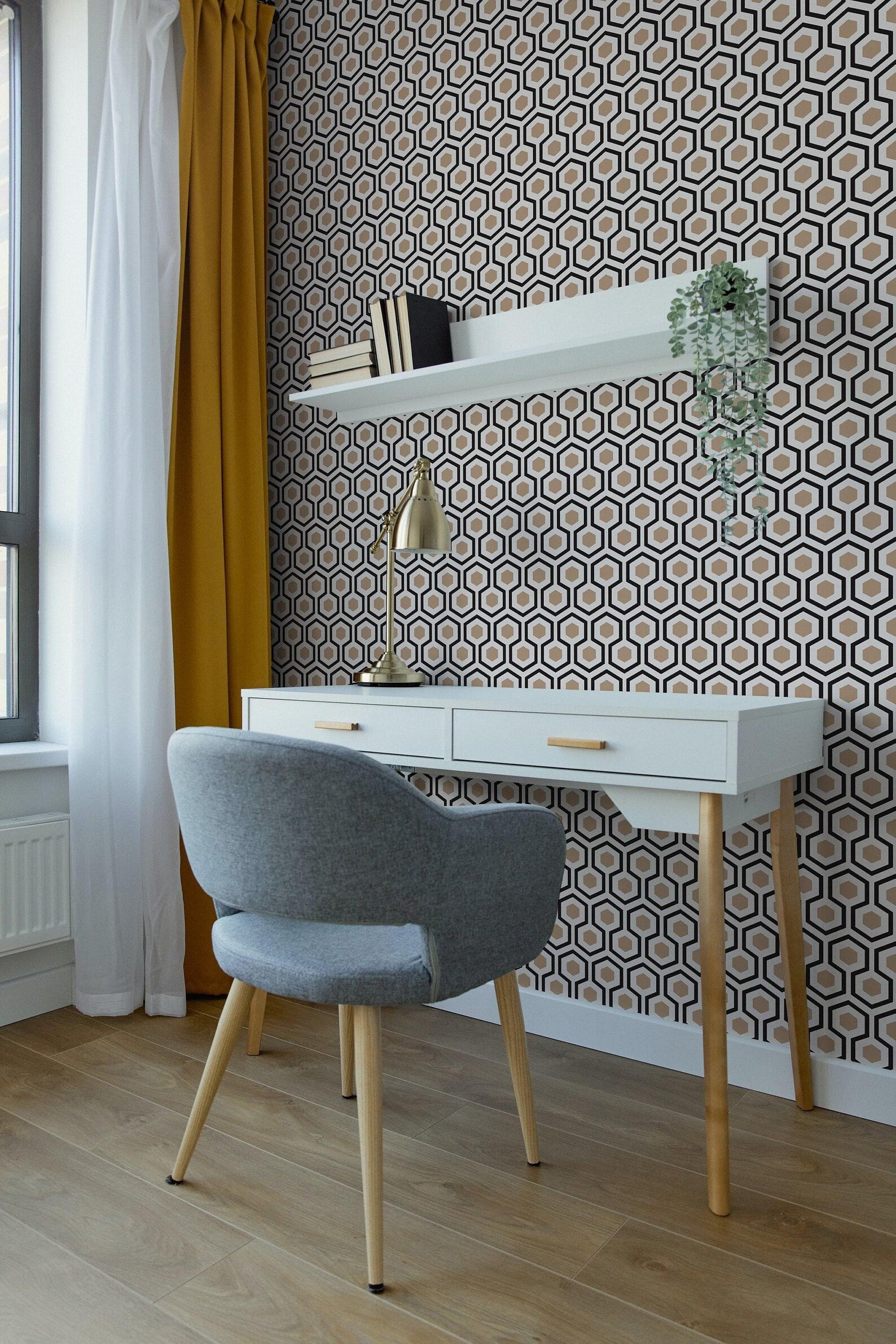 a modern and stylish workspace with a white desk, a gray armchair, and a patterned wall behind the desk.