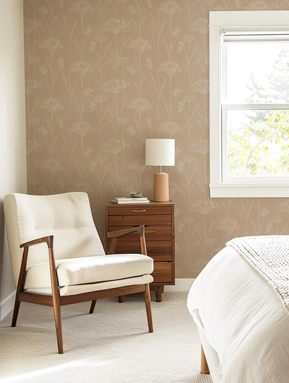 a cozy bedroom with a white armchair, a wooden side table with a lamp, and a window with a view of trees outside.