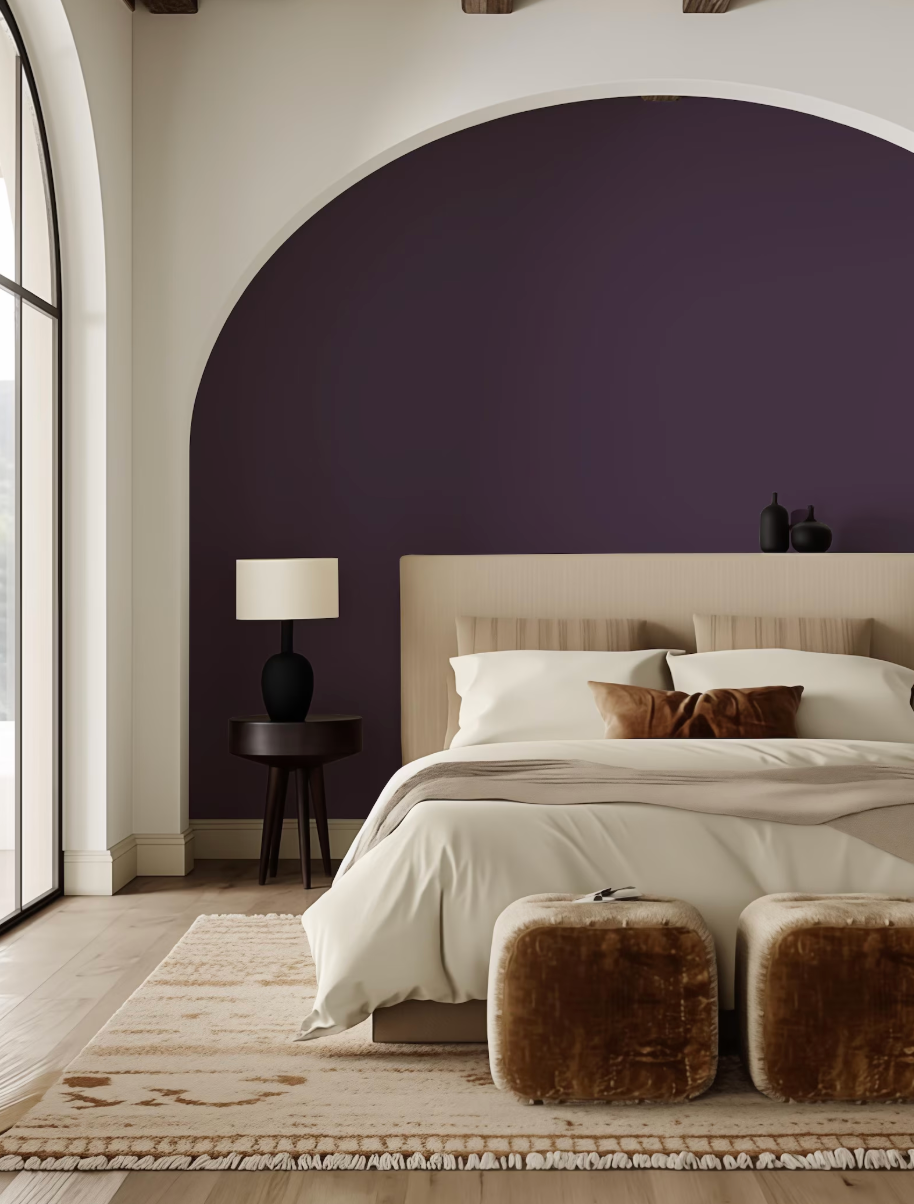 a modern bedroom with a large bed, a nightstand, and a rug. The room has a purple accent wall and a large arched window.