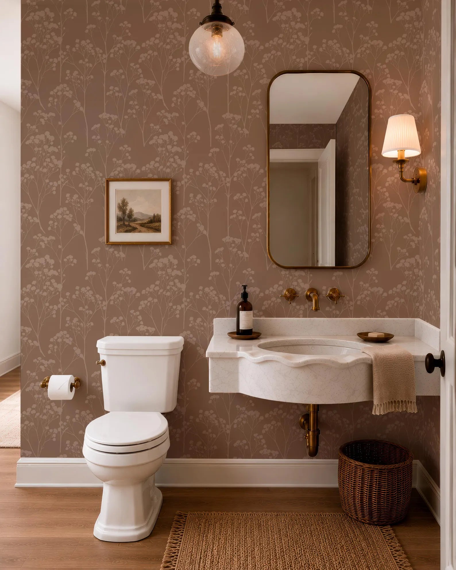a well-designed bathroom with a white toilet, a sink, and a mirror. The walls are covered in a floral wallpaper, and there is a painting hanging above the toilet. The room has a warm and inviting atmosphere, with a wooden floor and a wicker basket on the floor.