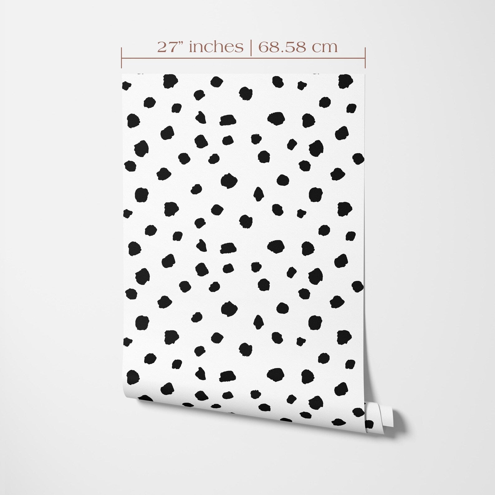 a white wall with a pattern of black dots or spots, creating a visually striking design.