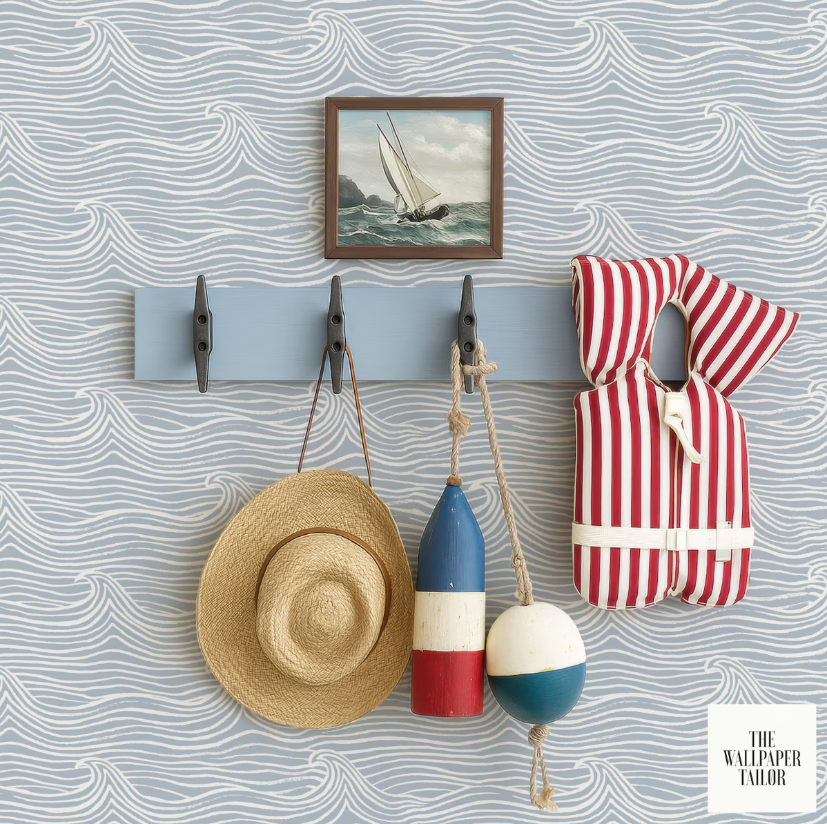 a wall with a blue and white wave wallpaper, a framed picture of a sailboat, a hat, a life preserver, and a buoy hanging on a rack.