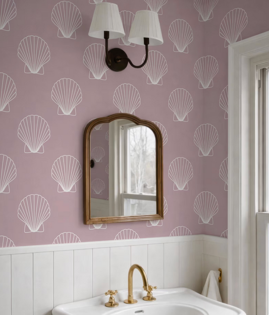 a bathroom with a white sink, a mirror, and a light fixture above it. The walls are decorated with a pattern of white seashells, creating a coastal or nautical theme.