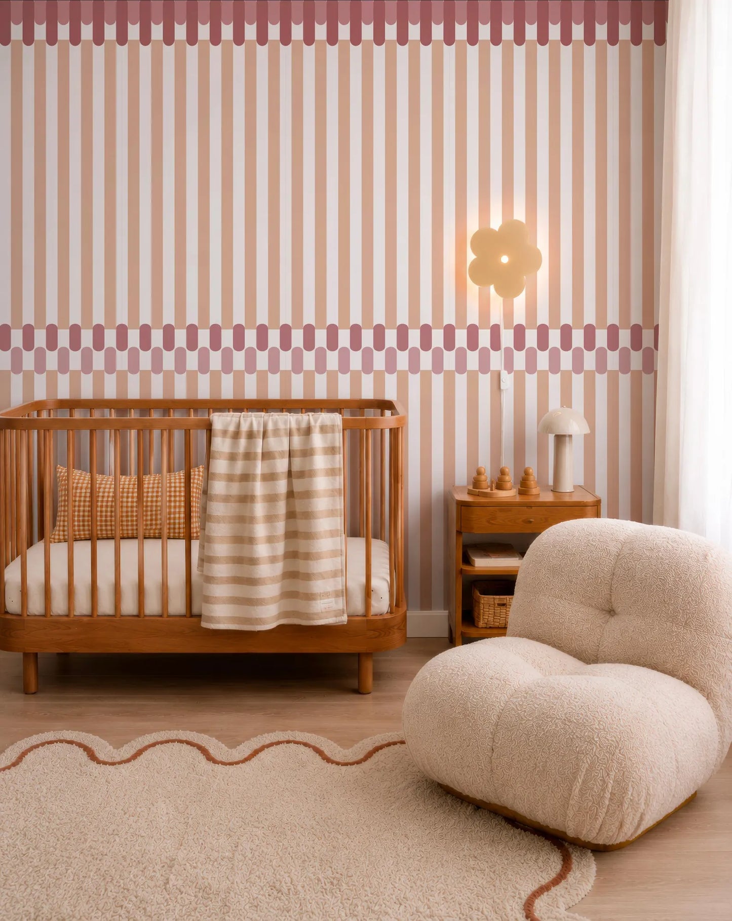 a cozy nursery room with a wooden crib, a plush chair, and a striped wall with a flower-shaped light fixture.