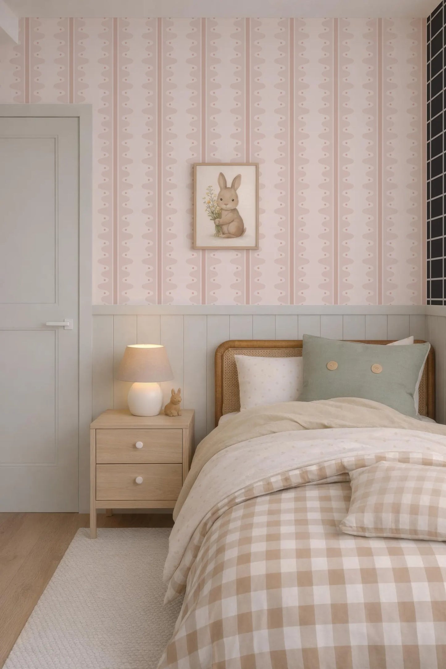 a cozy bedroom with a bed, nightstand, and a framed picture of a rabbit on the wall. The room has a pink and white color scheme, and the bed is covered with a checkered comforter and pillows.