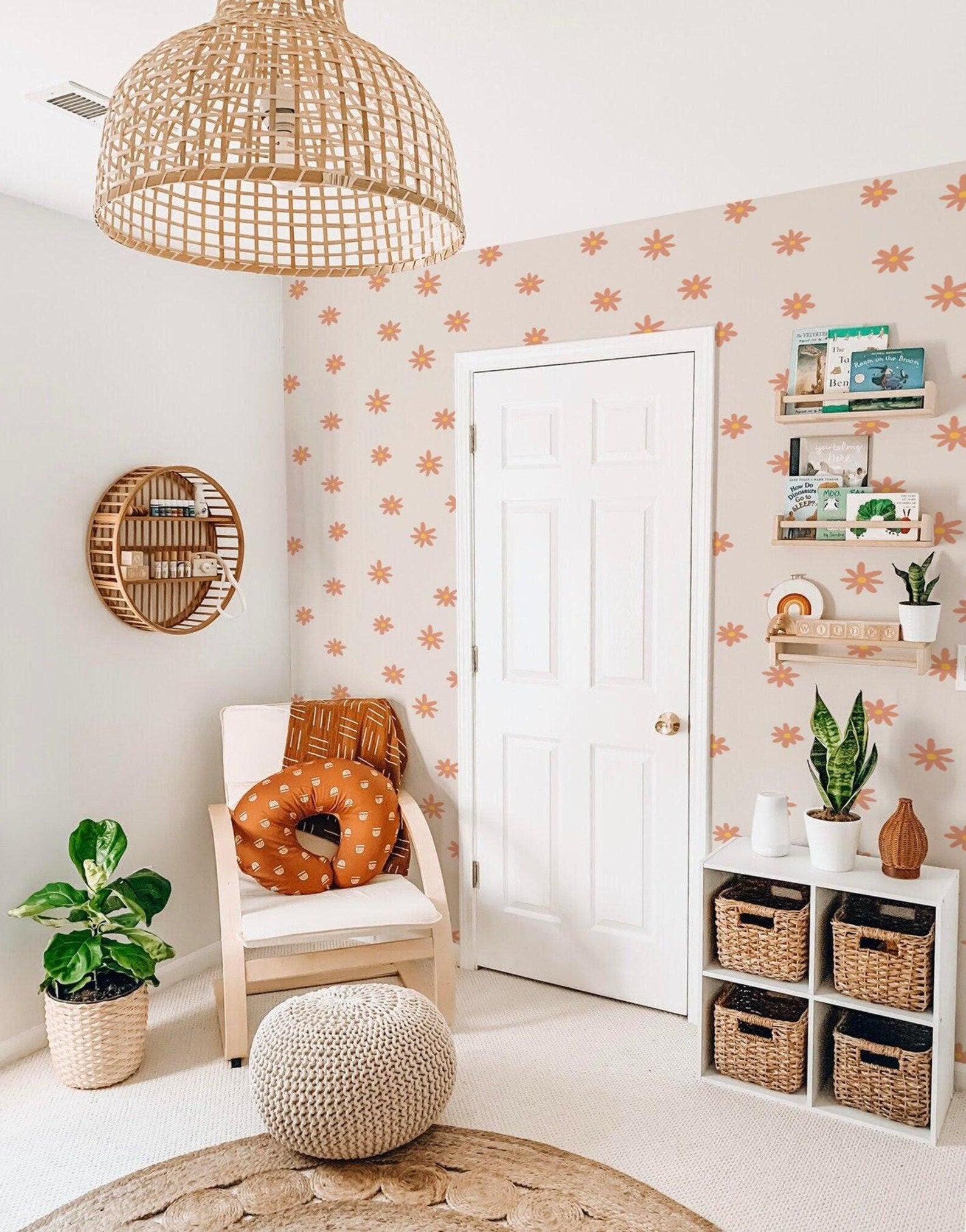 a cozy and inviting living space with a white door, a wicker basket shelf, a woven chair, a woven ottoman, and a potted plant. The walls are decorated with orange and white star patterns, and the room has a warm and rustic aesthetic.
