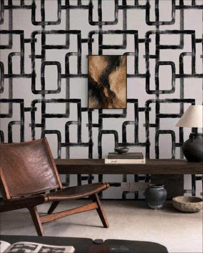 a modern living room with a leather chair, a wooden coffee table, and a black and white abstract wallpaper.