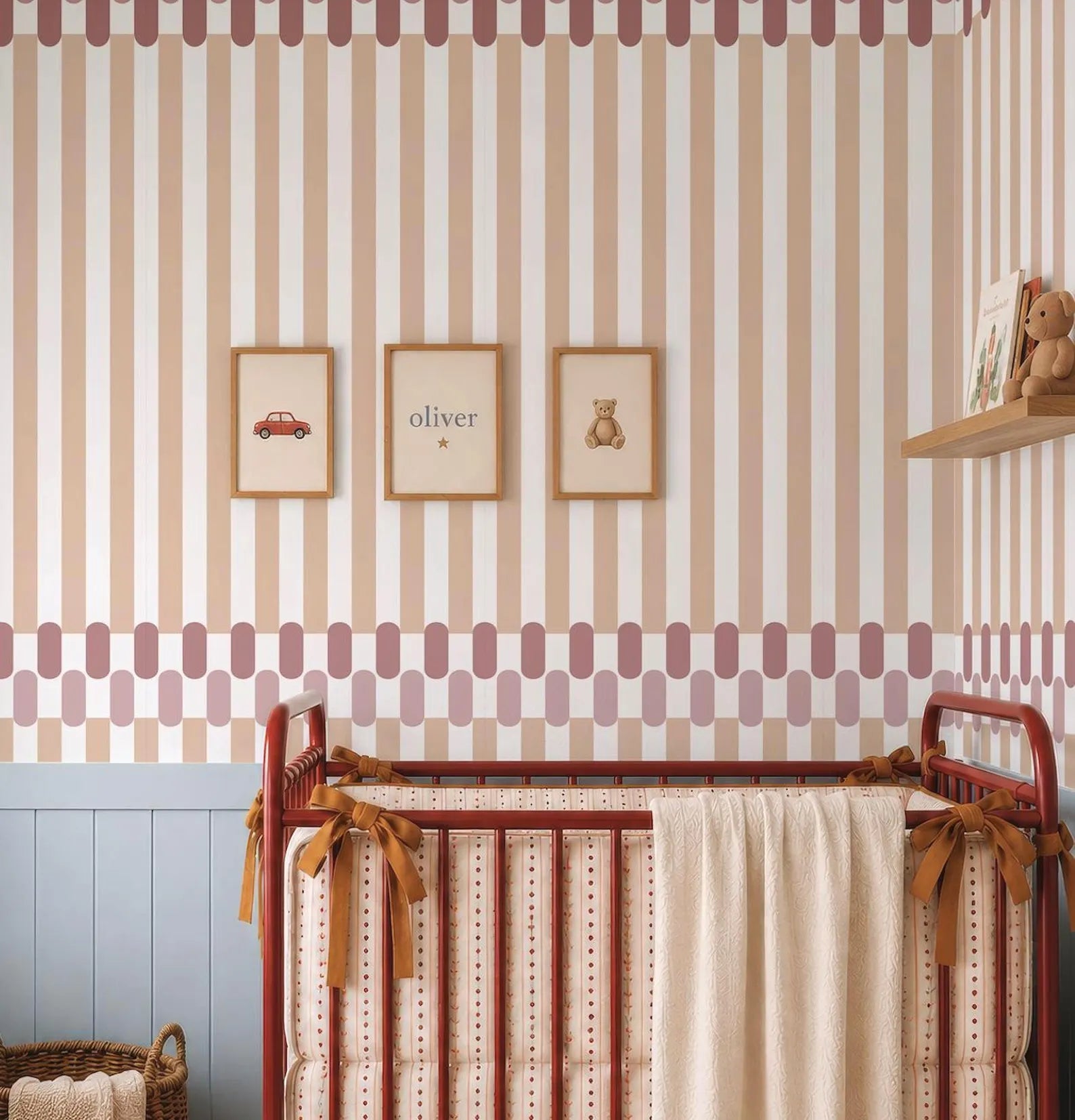 a nursery room with a red metal crib, a wooden shelf with a stuffed animal, and three framed pictures on the wall.