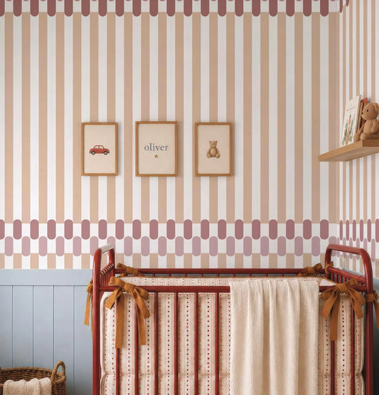 a nursery room with a red metal crib, a wooden shelf with a stuffed animal, and three framed pictures on the wall.