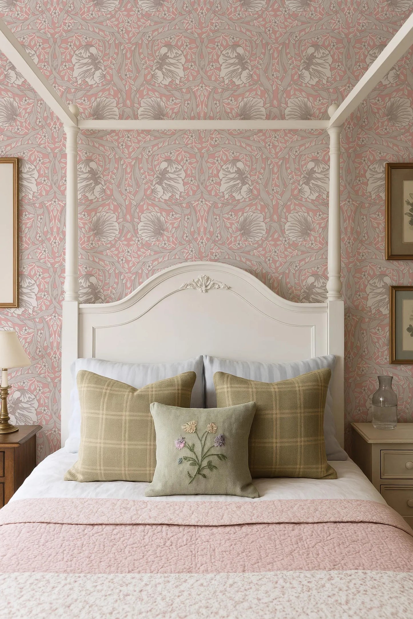 a cozy bedroom with a white canopy bed, a pink and white floral wallpaper, and a white headboard. The bed is adorned with three plaid pillows and a single green pillow with a floral design. The overall color scheme and design elements create a warm and inviting atmosphere.
