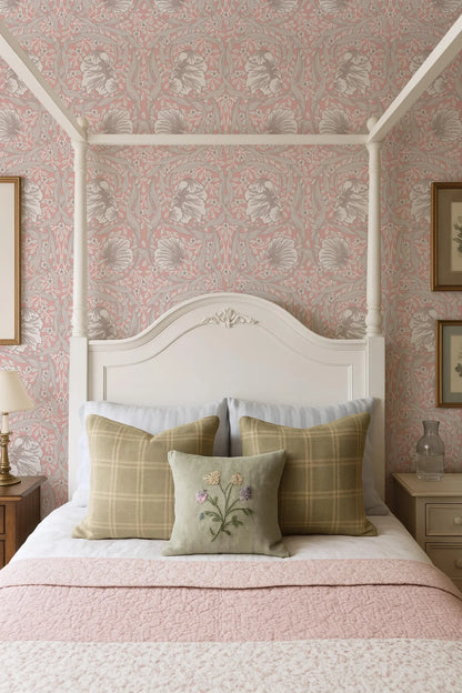 a cozy bedroom with a white canopy bed, a pink and white floral wallpaper, and a white headboard. The bed is adorned with three plaid pillows and a single green pillow with a floral design. The overall color scheme and design elements create a warm and inviting atmosphere.