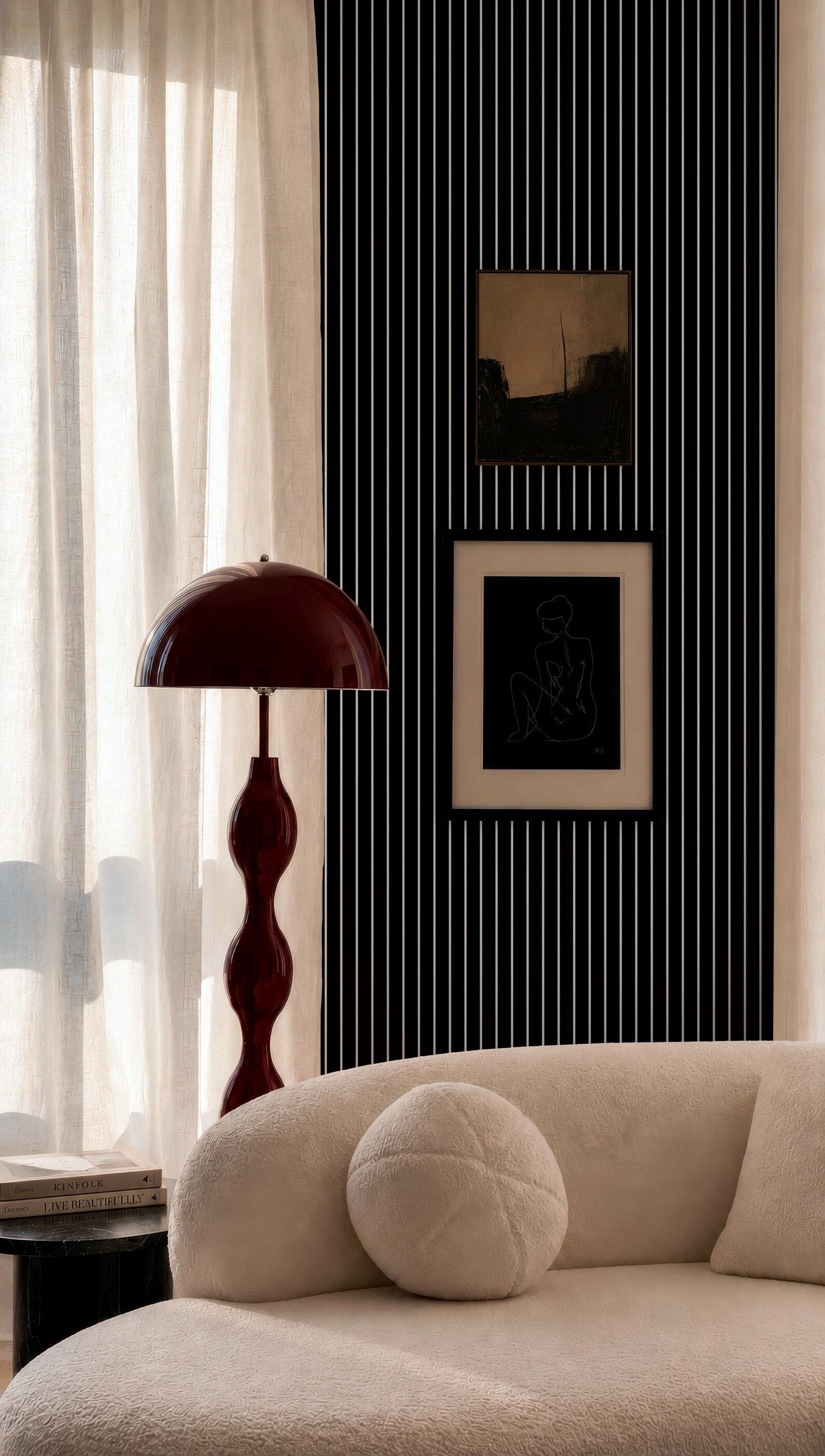 a modern living room with a white sofa, a red floor lamp, and a black and white striped wall.