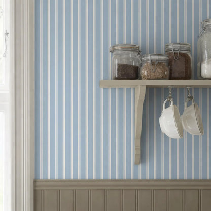 A wooden shelf mounted on a wall, holding various jars and containers, including coffee cups.