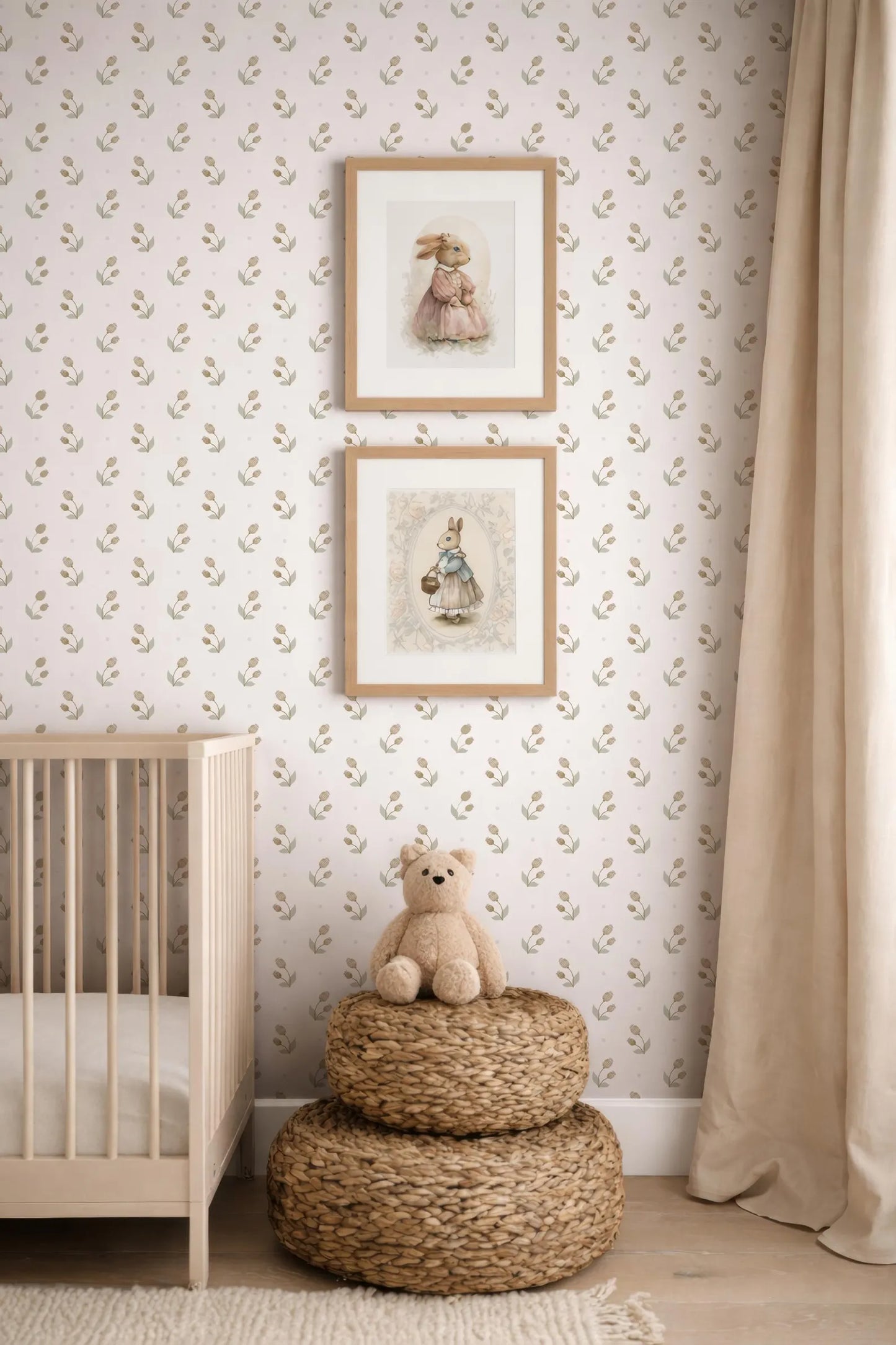 a cozy nursery scene with a wooden crib, a beige wall with a patterned wallpaper, and two framed pictures of rabbits. A small teddy bear is sitting on a woven basket in the foreground.