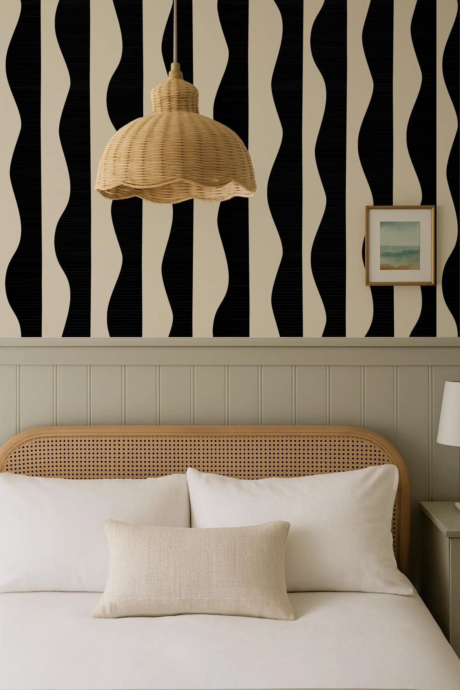 a bedroom with a bed, a wicker pendant lamp, and a black and white striped wallpaper.