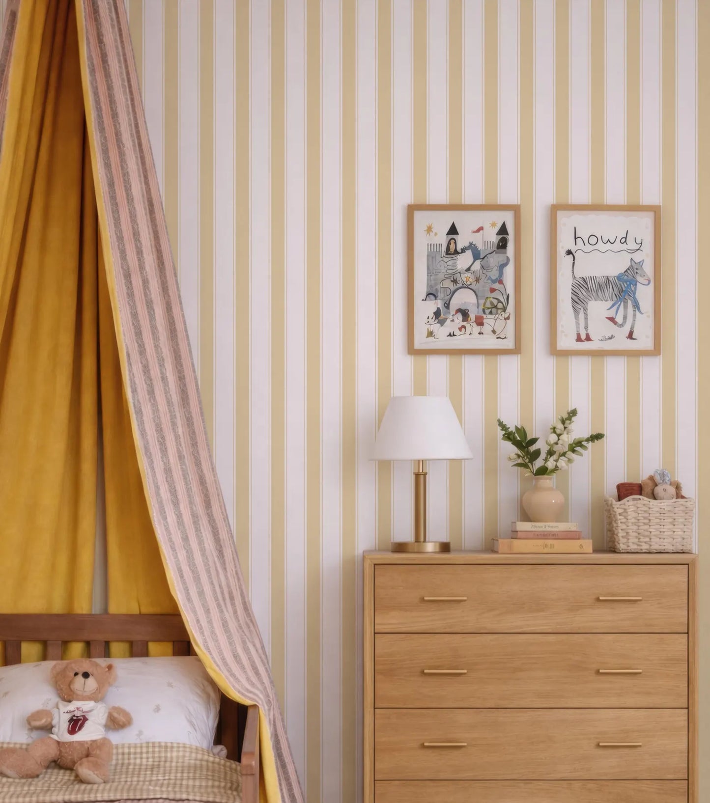 a cozy and colorful bedroom scene, featuring a wooden dresser with a lamp, a teddy bear, and a framed picture on the wall.