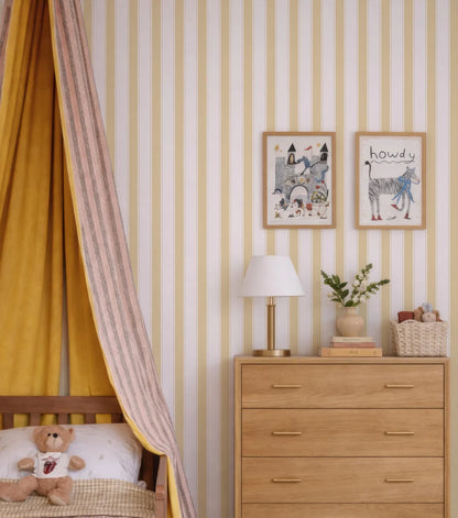 a cozy and colorful bedroom scene, featuring a wooden dresser with a lamp, a teddy bear, and a framed picture on the wall.