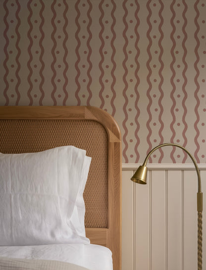 a cozy bedroom scene with a wooden headboard, a white bedding set, and a lamp on a side table.