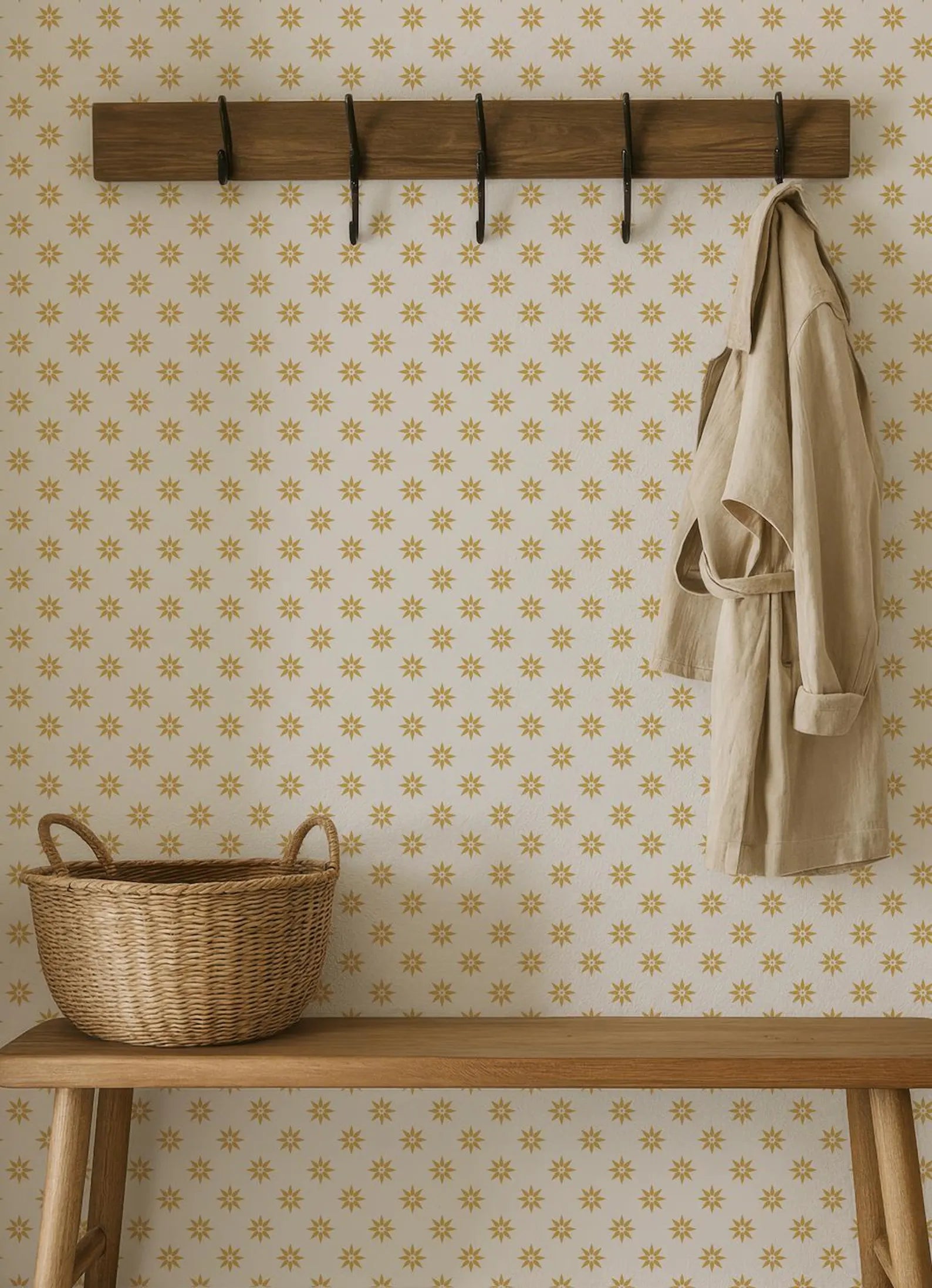 a wooden bench with a wicker basket on it, set against a wall with a patterned wallpaper.