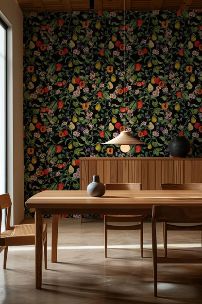 a dining room with a wooden table and chairs, a hanging light fixture, and a wallpapered wall with a floral pattern.