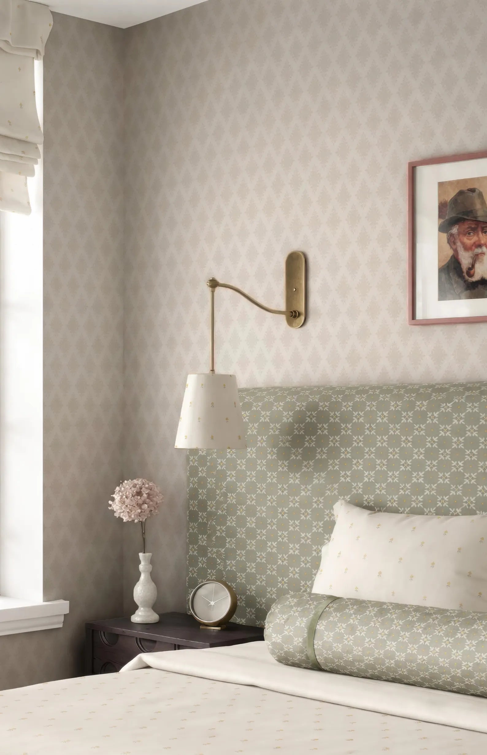 a cozy bedroom with a bed, a nightstand, and a lamp. The bed has a green and white patterned headboard, and there is a framed picture on the wall above it. The nightstand has a white vase with a pink flower, and there is a clock on the nightstand. The lamp is mounted on the wall above the bed.