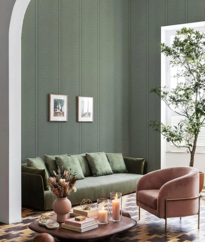 a cozy living room with a green sofa, a pink armchair, and a wooden coffee table. The room is decorated with a green patterned wallpaper, a white archway, and two framed pictures on the wall. There is also a potted plant and a vase of flowers on the coffee table, adding a touch of nature and color to the space.
