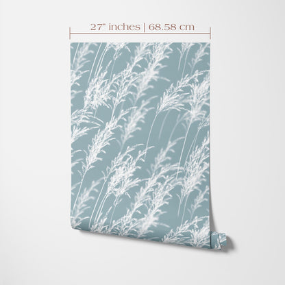 a piece of paper or fabric with a repeating pattern of white flowers or leaves against a light blue background.