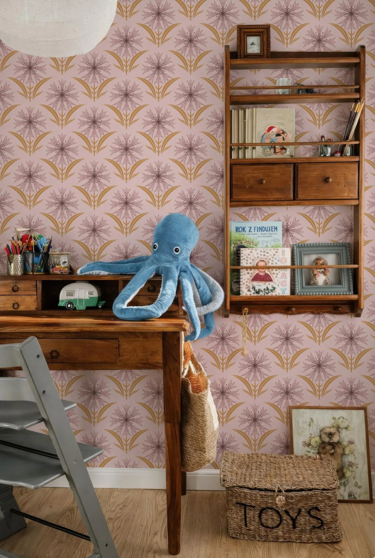 a cozy and colorful room with a wooden desk, a bookshelf, and a stuffed octopus toy. The walls are adorned with a floral pattern, and the room has a warm and inviting atmosphere.