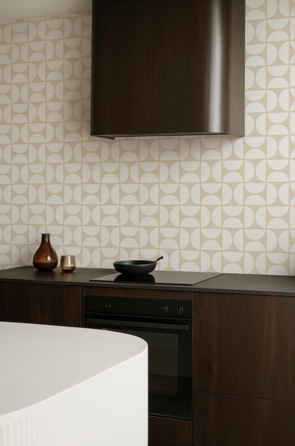 a modern kitchen with a black range hood, a white countertop, and a black oven. The kitchen has a minimalist and clean design, with a focus on the black and white color scheme.