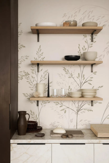 a kitchen counter with three wooden shelves displaying various kitchen items, including bowls, plates, and a vase.
