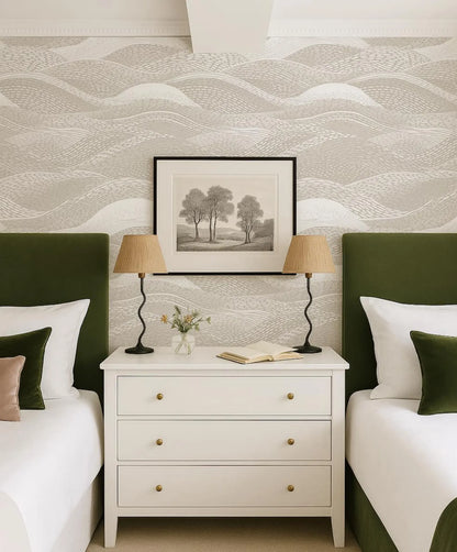 a cozy bedroom with a white dresser, two green headboards, and a framed landscape painting above the dresser. The room has a harmonious color scheme and a well-organized layout.