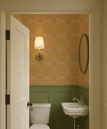 a bathroom with a white toilet, sink, and a mirror above the sink. The walls are covered in a patterned wallpaper with a repeating design of circles and lines. The door is open, revealing the bathroom interior.